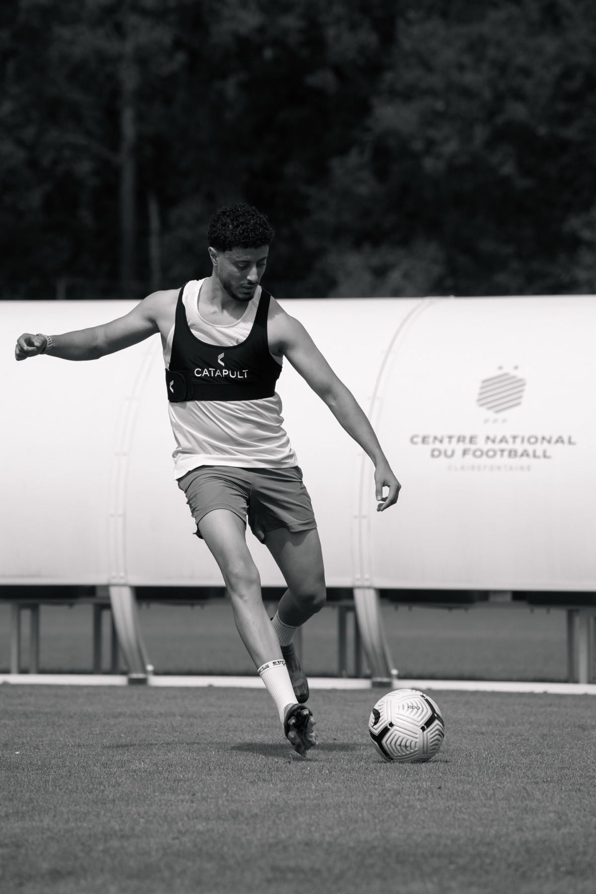 Adel Beggah striking the ball in training, black and white
